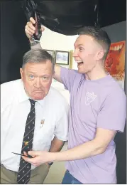  ?? (Pic: Sean Burke) ?? SOME FUN! - CBS teacher John Rea, about to undergo the big shave with a helping hand from past pupil Mike Stack, Stack’s Barbers.