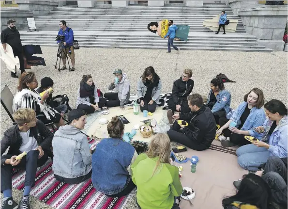  ?? ED KAISER ?? Members of Climate Justice Edmonton held a small celebrator­y rally at the Alberta legislatur­e on Thursday in response to the Federal Court of Appeal ruling quashing constructi­on approvals for the Trans Mountain pipeline expansion.