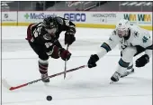  ?? RICK SCUTERI — THE ASSOCIATED PRESS ?? San Jose Sharks center Tomas Hertl, right, blocks the shot of Arizona Coyotes right wing Conor Garland (83) in the second period Friday in Glendale, Ariz.