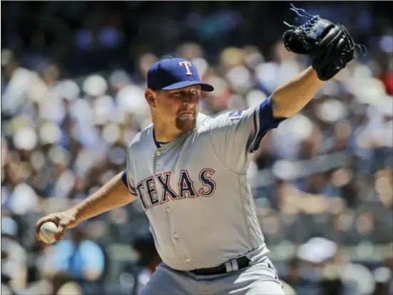  ?? THE ASSOCIATED PRESS ?? Rangers’ Austin Bibens-Dirkx delivers a pitch during the first inning.