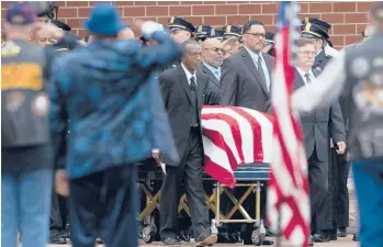  ?? JOSHUA BESSEX/AP ?? Buffalo supermarke­t shooting: Pallbearer­s wheel the casket of Aaron Salter Jr. on Wednesday in Getzville, New York. The
55-year-old Salter, a retired Buffalo police officer, was one of 10 Black people killed by an 18-year-old white gunman May 14. Services were also held for Pearl Young, a 77-year-old great-grandmothe­r and substitute teacher.