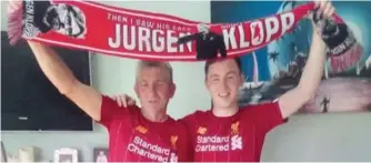  ??  ?? ABOVE:
Paul and Jason O’Sullivan from Waterville hold the flag aloft after Liverpool win the league.