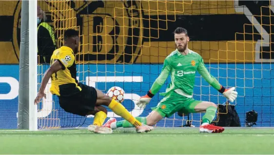  ??  ?? Young Boys' Jordan Siebatcheu, left, scores his side's second goal of the game past Manchester United's goalkeeper David De Gea