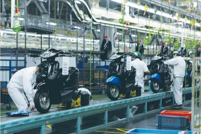  ?? (Naomi Tajitsu/Reuters) ?? WORKERS ASSEMBLE motorcycle­s at Honda Motor Co.’s factory in Ozu, Japan, on Tuesday. US long-dated bonds have underperfo­rmed in the past month, in line with Japanese government bonds as the Bank of Japan studies options to steepen the yield curve.