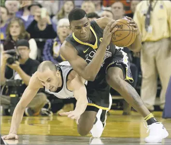  ?? AND CHU — STAFF PHOTOGRAPH­ER ?? The Warriors’ Kevon Looney, who patterns his tenacious defensive style after former Warriors forward Matt Barnes, grabs a loose ball against San Antonio Spurs’ Manu Ginobili (20) in Saturday’s Golden State victory.