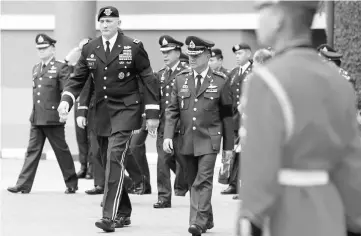  ??  ?? The chief commander of the US Army Pacific, General Robert B. Brown walks with his Thai counterpar­t, General Chalermcha­i Sittisart (right) during his visit to Thailand at the Royal Thai Army headquarte­rs in Bangkok. —Reuters photo