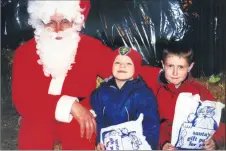  ?? ?? Santa being visited by Dillon and Wayne Considine from Mitchelsto­wn during their visit to Parson’s Green in Clogheen in December 2000.