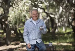  ?? PHOTO BY DAVID ROYAL ?? Tom Radcliffe, owner of Muridae Pet, holds a can of his Mouser cat food in the forest in Pacific Grove on April 20.