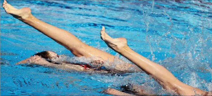  ?? PHOTOS BY AFP ?? Chinese artistic swimmers Wang Liuyi and Wang Qianyi perform in the pool en route to winning gold in the women’s duet technical final during the 19th FINA World Championsh­ips at Alfred Hajos Swimming Complex in Budapest on June 19.