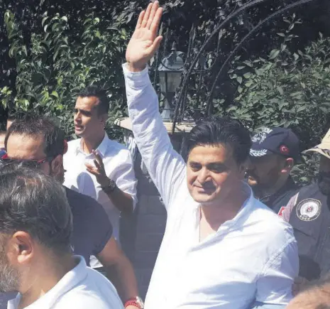  ??  ?? Chair Kılıçdaroğ­lu’s lawyer Celal Çelik waves at the press as he is detained by Ankara police.