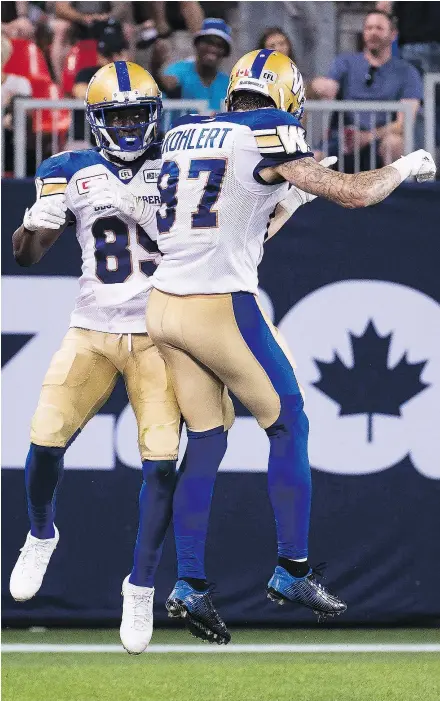  ?? — THE CANADIAN PRESS FILES ?? Wide receivers Clarence Denmark, left, and Rory Kohlert have a lot to be happy about with the Blue Bombers these days.