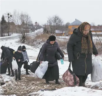  ?? Dan Kitwood / Getty Images News ?? Refugees leaving Ukraine on their way to Poland earlier this month.