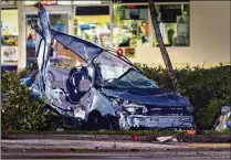  ?? LANNIS WATERS / THE PALM BEACH POST ?? A vehicle sits near a BP station after the May 7 crash at Military Trail and Belvedere Road. The Sheriff’s Office said it’s looking into which vehicle ran the red light.