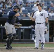  ?? SETH WENIG — ASSOCIATED PRESS ?? Brewers catcher Stephen Vogt, left, removes his mask, as Yankees’ Gary Sanchez reacts after striking out to end game on Sunday.