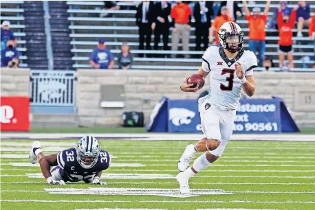  ??  ?? Oklahoma State quarterbac­k Spencer Sanders (3) leaves Kansas State linebacker Justin Hughes (32) on the turf behind him on a run Saturday during the Cowboys' 20-18 win in Manhattan, Kansas. [SCOTT SEWELL/USA TODAY SPORTS]