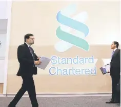  ??  ?? People pass by the logo of Standard Chartered plc at the SIBOS banking and financial conference in Toronto, Ontario, Canada. — Reuters photo