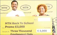  ?? (Courtesy pic) ?? Zodwa Ndzimandze (R) receives her E3 000 weekly prize from local comedian Mdura.