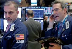  ?? — Reuters ?? Traders work on the floor of the New York Stock Exchange. The uptick in inflation last week has already shifted the market’s expectatio­ns on the US Federal Reserve’s next move.