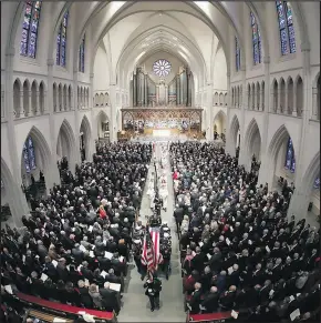  ?? — THE ASSOCIATED PRESS ?? The flag-draped casket of George H.W. Bush is carried out of St. Martin’s Episcopal Church in Houston yesterday.