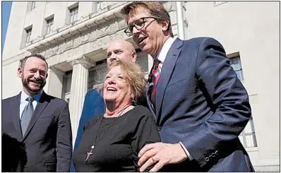  ?? AP/St. Louis Post-Dispatch/CHRISTIAN GOODEN ?? Plaintiff Gail Ingham stands outside a St. Louis courthouse with the plaintiffs’ attorneys after Thursday’s decision in a lawsuit that blamed 22 women’s ovarian cancer on asbestos in Johnson &amp; Johnson’s talc products.