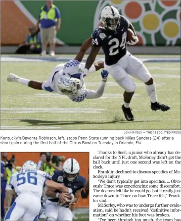  ?? JOHN RAOUX — THE ASSOCIATED PRESS ?? Kentucky’s Davonte Robinson, left, stops Penn State running back Miles Sanders (24) after a short gain during the first half of the Citrus Bowl on Tuesday in Orlando, Fla.