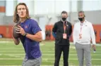  ?? USA TODAY ?? Quarterbac­k Trevor Lawrence works out as Jaguars head coach Urban Meyer (far right) looks on during Clemson Pro Day on Feb 12.