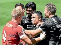  ??  ?? New Zealand players mix it up with Canada’s John Moonlight during their Pool C match at the Cape Town Sevens.