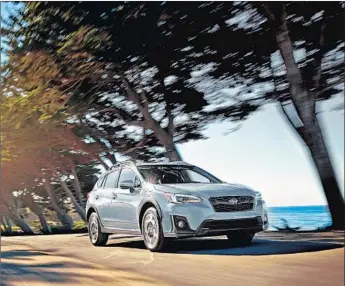  ?? Subaru ?? THE SUBARU Crosstrek, shown in its Limited trim, is not as swanky as the automaker’s top Outbacks nor as spare as a stripped-down Forester. It drives like a sedan but also offers sturdiness and cargo space.