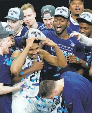  ?? ERIC GAY AP ?? Villanova forward Jermaine Samuels celebrates with teammates after their win against Houston in the Elite Eight, earning the Wildcats a trip to the Final Four for the first time since 2018.