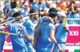  ?? AFP ?? ▪ Harmanpree­t Singh (second from right) is congratula­ted by teammates after scoring his second goal against Malaysia on Tuesday. India won 21.