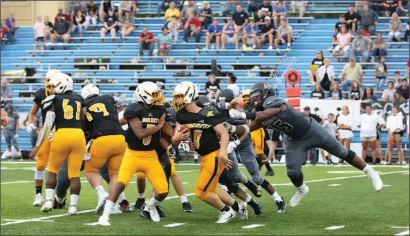  ?? Rhonda Sharp/Special to the News-Times ?? Come back here: Smackover's Damarous White tugs on the jersey of Harmony Grove's Gannon Bearden during their contest at the Arkansas Blue Cross and Blue Shield Kickoff Classic at Southern Arkansas University on Tuesday in Magnolia. The Bucks rallied...