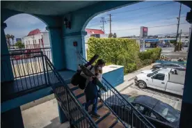  ?? Photograph: Apu Gomes/AFP via Getty Images ?? Julie Mariane leaves a motel room provided to homeless people by the nonprofit St Joseph Center, as she gets ready to be transferre­d to a hotel room in Venice Beach, California, on 26 April 2020.