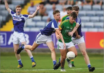  ??  ?? Luke Kelly of Meath is tackled by Niall Carey, left, and Sean Micheal Corcoran.