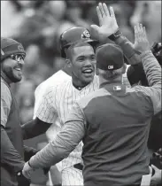  ?? BRIAN CASSELLA/TRIBUNE NEWS SERVICE ?? The Cubs' Addison Russell celebrates his walk-off 3-run home run against the Brewers on Wednesday in Chicago.