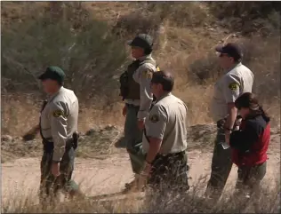  ?? Austin Dave/The ?? The Santa Clarita Valley Sheriff’s Station’s search and rescue team arrives to the scene of a plane crash in Agua Dulce on Sunday. Officials confirmed that the four people were family members.