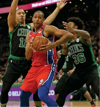  ?? STUART CAHILL / HERALD STAFF FILE ?? BACK IN GREEN: Forward Al Horford, then with the Philadelph­ia 76ers, drives to the net against Grant Williams, left, and Marcus Smart on Feb. 1, 2020.