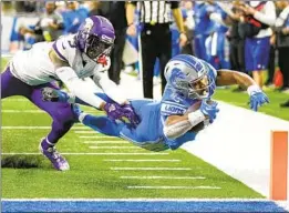  ?? Paul Sancya Associated Press ?? LIONS RUNNING BACK Justin Jackson dives past Vikings cornerback Cameron Dantzler Sr. for a touchdown in the fourth quarter of Detroit’s 34-23 victory.