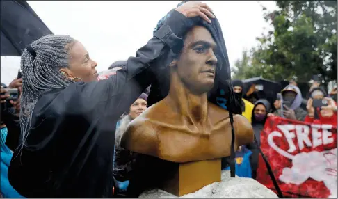  ?? (AP/Bay Area News Group/Jane Tyska) ?? Fredrika Newton unveils Oct. 24 a bust sculpted by artist Dana King in memory of Dr. Huey P. Newton, Black Panther Party co-founder and her late husband, on Mandela Parkway at 9th Street in West Oakland, Calif. The event was hosted by the Dr. Huey P. Newton Foundation in honor of the 55th anniversar­y of the Black Panthers.