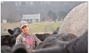  ?? STACI VANDAGRIFF/RIVER VALLEY & OZARK EDITION ?? Lori Reynolds stands among cattle at a ranch in Greenbrier that she and her husband, Terry, manage. They are fourth-generation cattle farmers with their own herd. Lori Reynolds, cancer-program outreach coordinato­r and staff nurse at Conway Regional Medical Center, was surprised with the DAISY Award earlier this month for her compassion and dedication to her job.