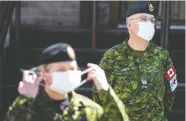  ?? CHRISTINNE MUSCHI / REUTERS ?? Armed Forces medical personnel help out Saturday at
Yvon-Brunet long-term care centre in Montreal.