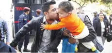  ??  ?? KATHMANDU: Nepalese national football team goalkeeper Ritesh Thapa kisses his son as he arrives during ongoing hearings into a corruption case at court in Kathmandu yesterday.