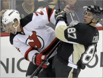  ?? AP Photo ?? Penguins’ Sidney Crosby, right, collides with Devils’ Marek Zidlicky. Pittsburgh won, 3-0.