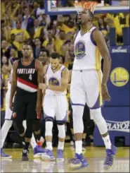  ?? JEFF CHIU — THE ASSOCIATED PRESS ?? Golden State Warriors forward Kevin Durant (35) reacts after scoring against the Portland Trail Blazers during the second half of Game 1 of a first-round NBA basketball playoff series in Oakland Sunday. The Warriors won 121109.