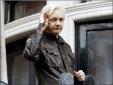  ?? FRANK AUGSTEIN, FILE - THE ASSOCIATED PRESS ?? In this 2017 file photo, WikiLeaks founder Julian Assange greets supporters from a balcony of the Ecuadorian embassy in London. The Justice Department’s indictment Fridayof 12 Russian military intelligen­ce officers for U.S. election hacking undermine...