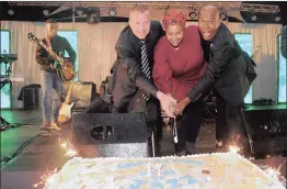  ??  ?? CELEBRATOR­Y: Lloyd Marshall, Noniah Madingoane and Jazzman Mahlakgane cut a cake to celebrate the jazz event’s 17th anniversar­y at Birchwood on Saturday.