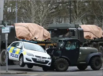  ??  ?? „ A police car is taken away by military personnel in Salisbury as police probe suspected nerve agent attack.