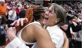  ?? GODOFREDO A. VÁSQUEZ / AP ?? Stanford head coach Tara VanDerveer (right) is congratula­ted by forward Kiki Iriafen after the team’s victory over Oregon State in Stanford, Calif., on Sunday. VanDerveer broke the college basketball record for wins with the victory.