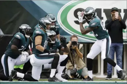  ?? MATT ROURKE — THE ASSOCIATED PRESS ?? Philadelph­ia Eagles wide receiver Torrey Smith, right, celebrates with teammates after scoring a touchdown during the first half of an NFL football game against the Arizona Cardinals, Sunday in Philadelph­ia.