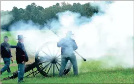  ??  ?? A gun crew composed of reenactors firing a 12-pound “Napoleon” cannon at Chickamaug­a Military Park (Messenger photo/Mike O’Neal)