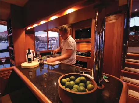  ??  ?? Scurvy is no problem aboard
Langano, as this generous bowl of limes readily attests. Gareth shows us the galley is suitable for social times, as when the boat is on the hook (far right). The crew enjoys a bright morning in the pilothouse.